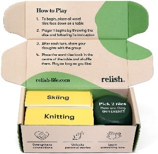 Two yellow boxes labeled “skiing” and “knitting” and a green canister in a brown cardboard box with green shapes.