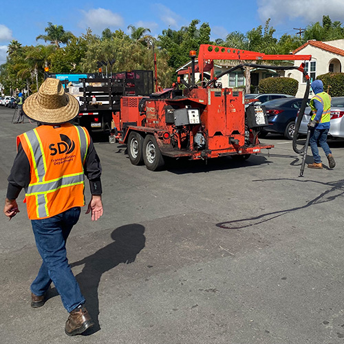 City workers sealing cracks on the road