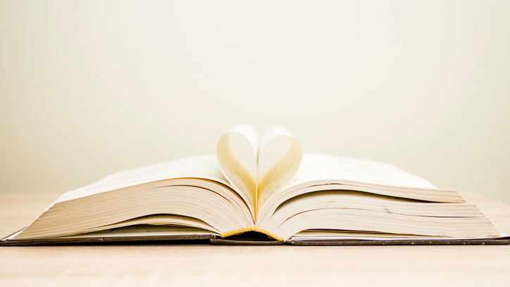 Photo of book with pages creating a heart