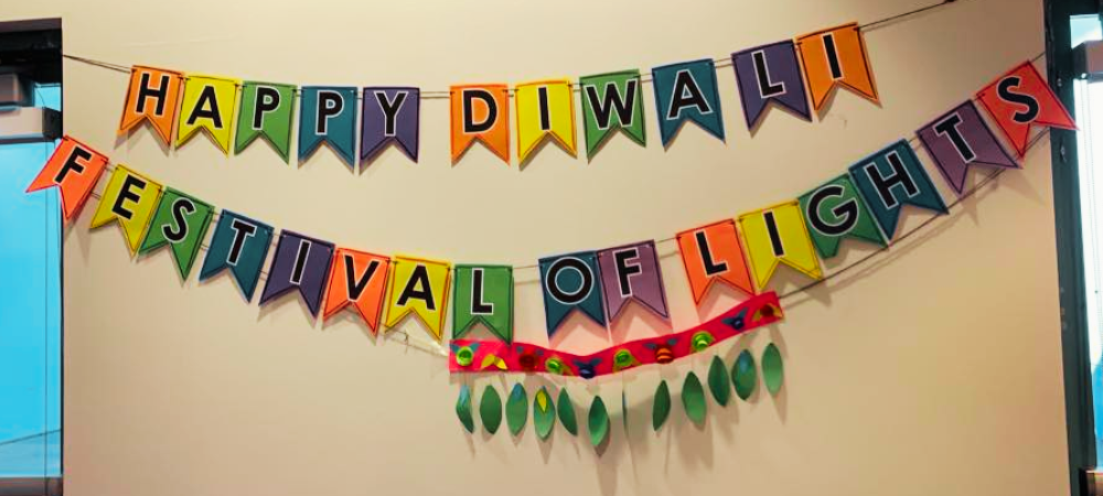 During Diwali, Mira Mesa Library recognizes the celebration in their community room, which they decorate with a rainbow pennant that spells out, “HAPPY DIWALI” and “FESTIVAL OF LIGHTS.” Below the rainbow pennant is a red ribbon of felt with a string of green light-shaped decorations.