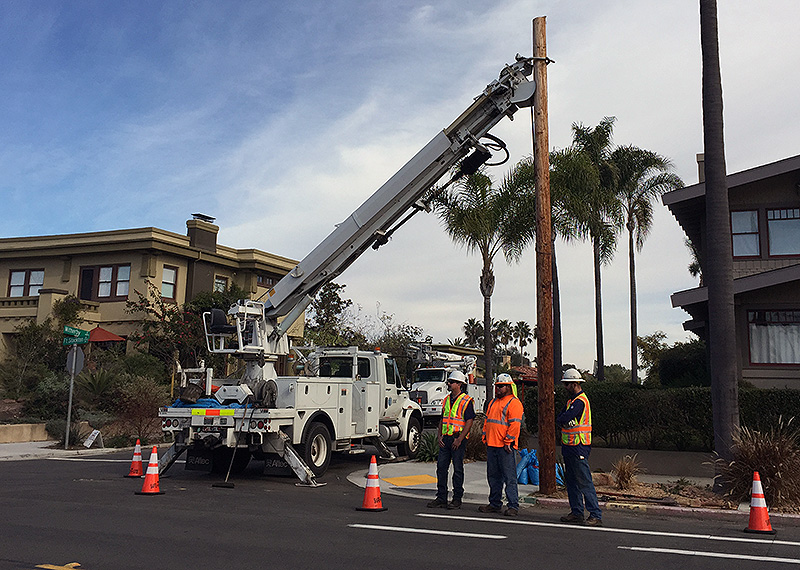 City workers removing a utility pole