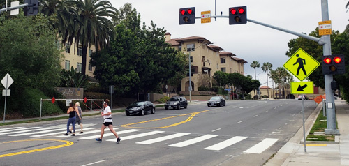 Pedestrians crossing the street on a improved crosswalk