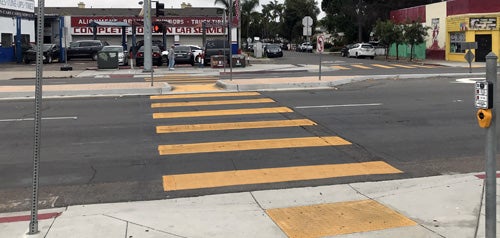 A newly installed crosswalk with highly visible markings and accessibility features 