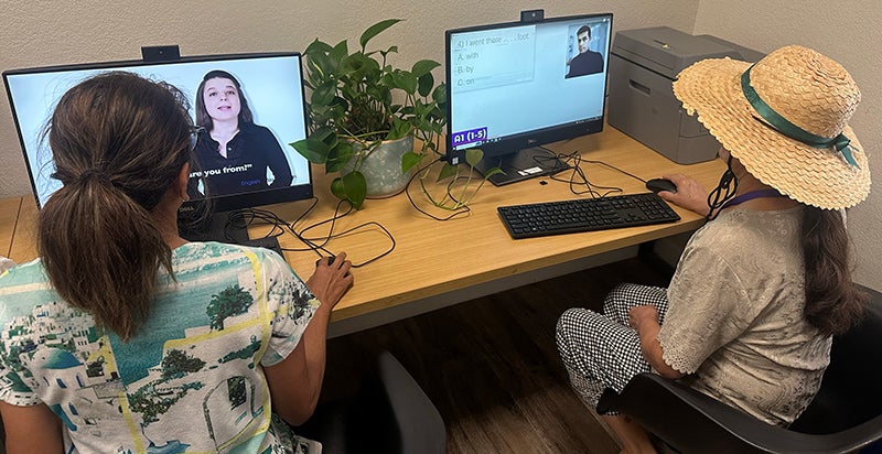 Two women using computers at a resource lab