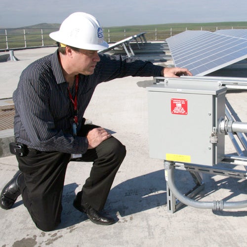 A technician inspecting solar panels