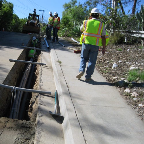 City staff placing utility lines underground