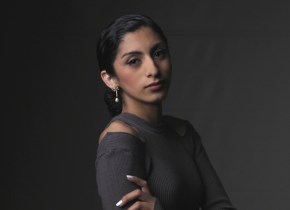 A portrait photograph of a woman with her hair pulled back wearing a grey top by an artist from the San Diego Portrait Club