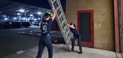 Fire cadets setting up a tall ladder during training