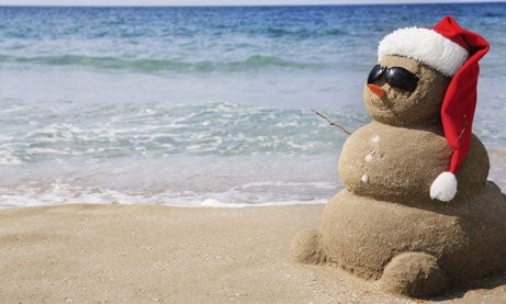 Photo of snow man made of sand at the beach