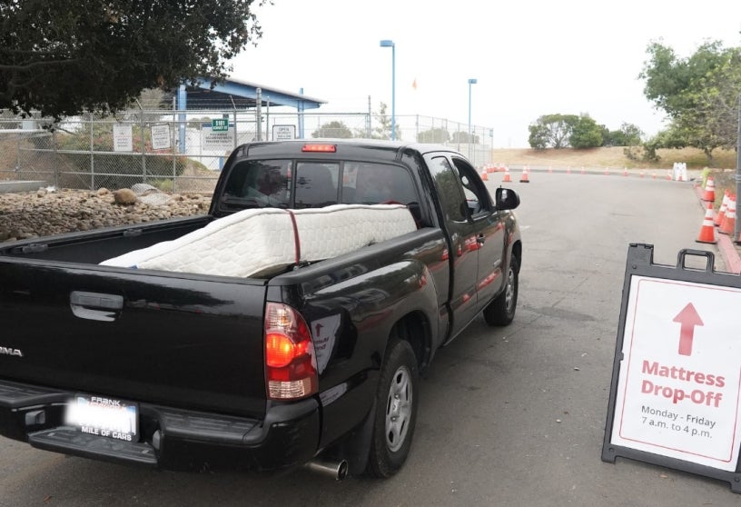 A truck carrying a mattress entering the mattress drop-off area.