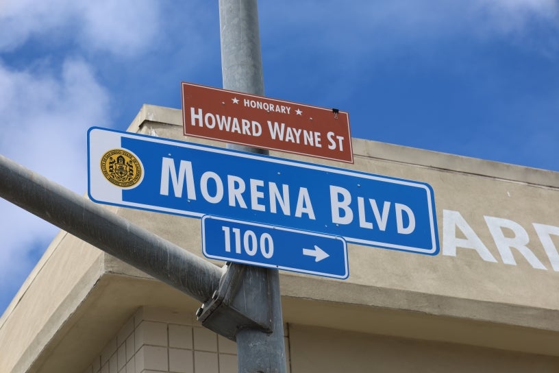 Howard Wayne St sign above Morena Blvd sign