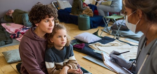 Mother and daughter receiving care at a homeless shelter