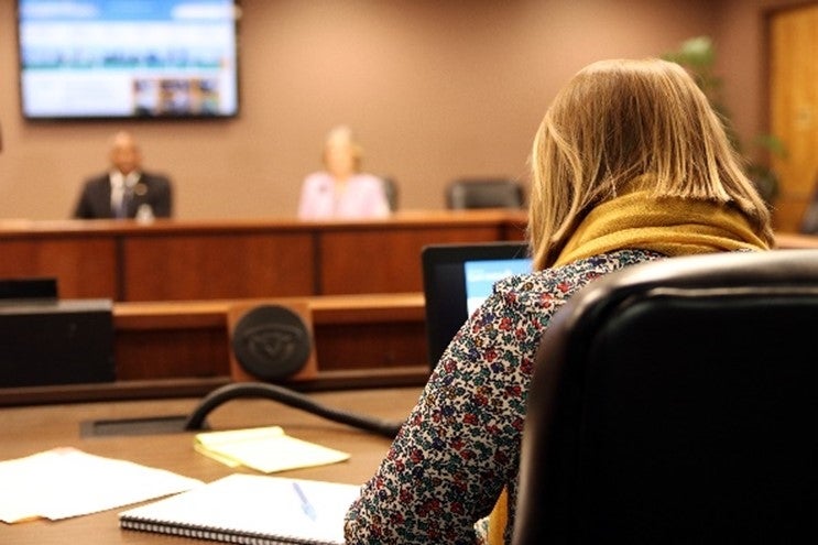 A person making a presentation to board members