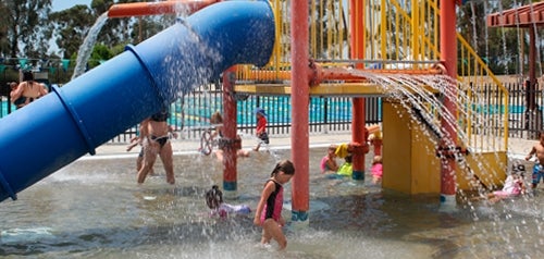 Children playing on an outdoor water structure