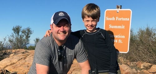 Man and child posing for a photo at South Fortuna Summit