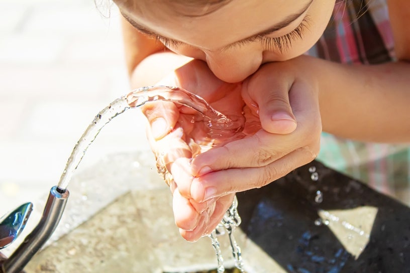 Child drinking from water fountain