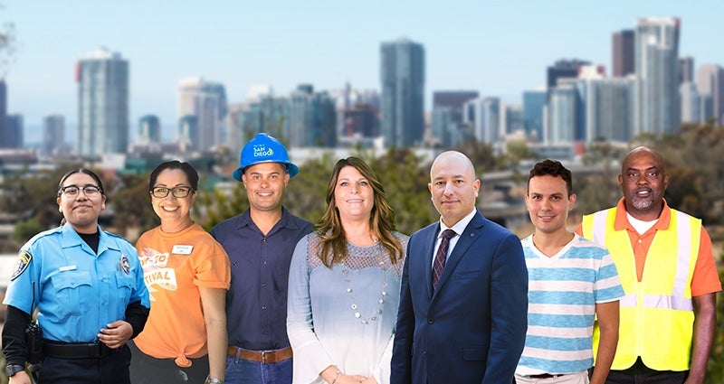 City employees in front of the San Diego downtown skyline