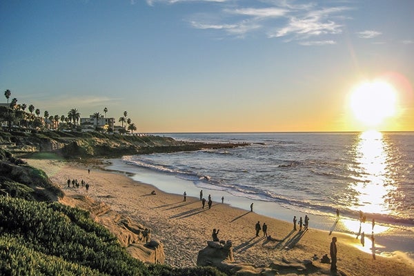 Beachgoers enjoying a sunset at Sunset Cliffs beach