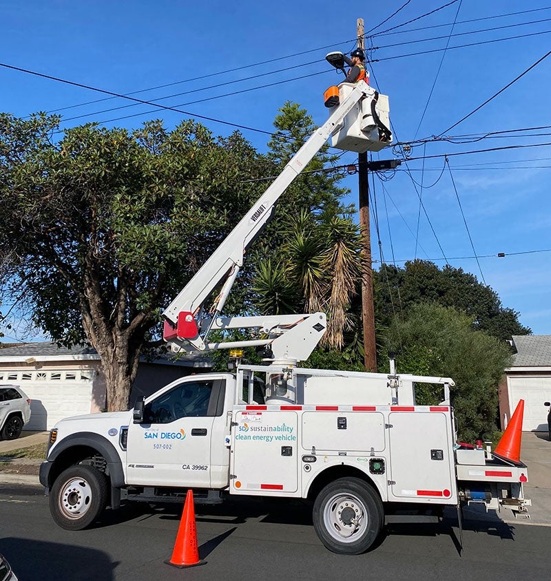 City electrician fixing a streetlight