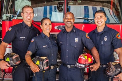 Photo of firefighters in front of firetruck