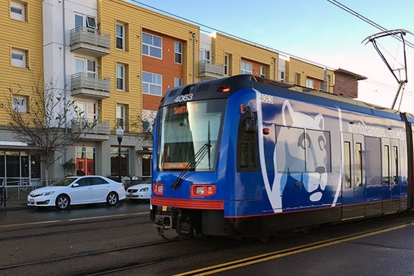 San Diego Trolley passing by an apartment building