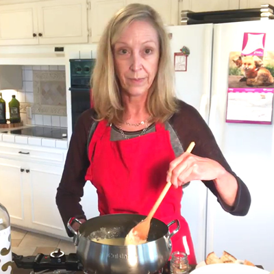 Library staff demonstrating how to make cheese fondue