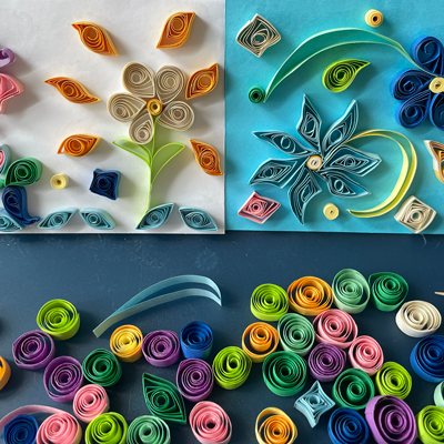 Collage of colorful flowers made out of paper quilling