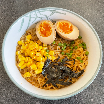 Image of a bowl of ramen with egg and corn