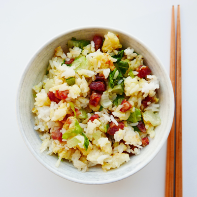 Bowl of fired rice with pair of chopsticks