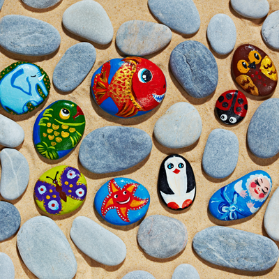 Image of painted rocks including fish and penguin