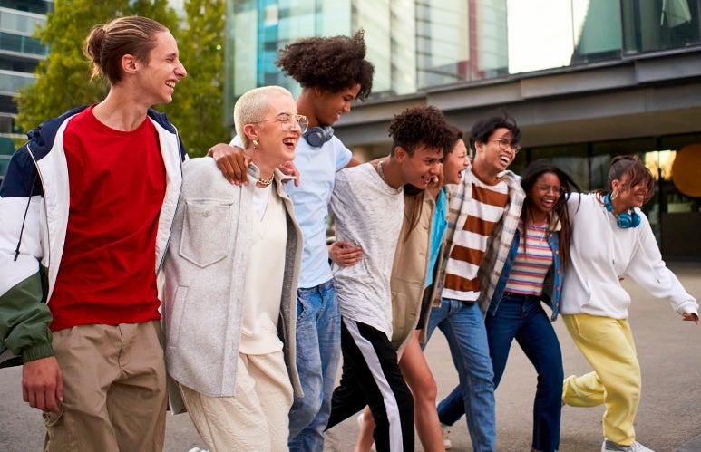 Multiracial group walking and laughing