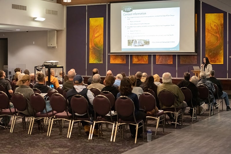 Attendees watching a presentation at the Block 7T Pre-construction Community Forum