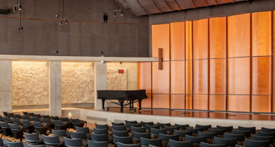 Interior of Neil Morgan Auditorium with Steinway piano on stage.