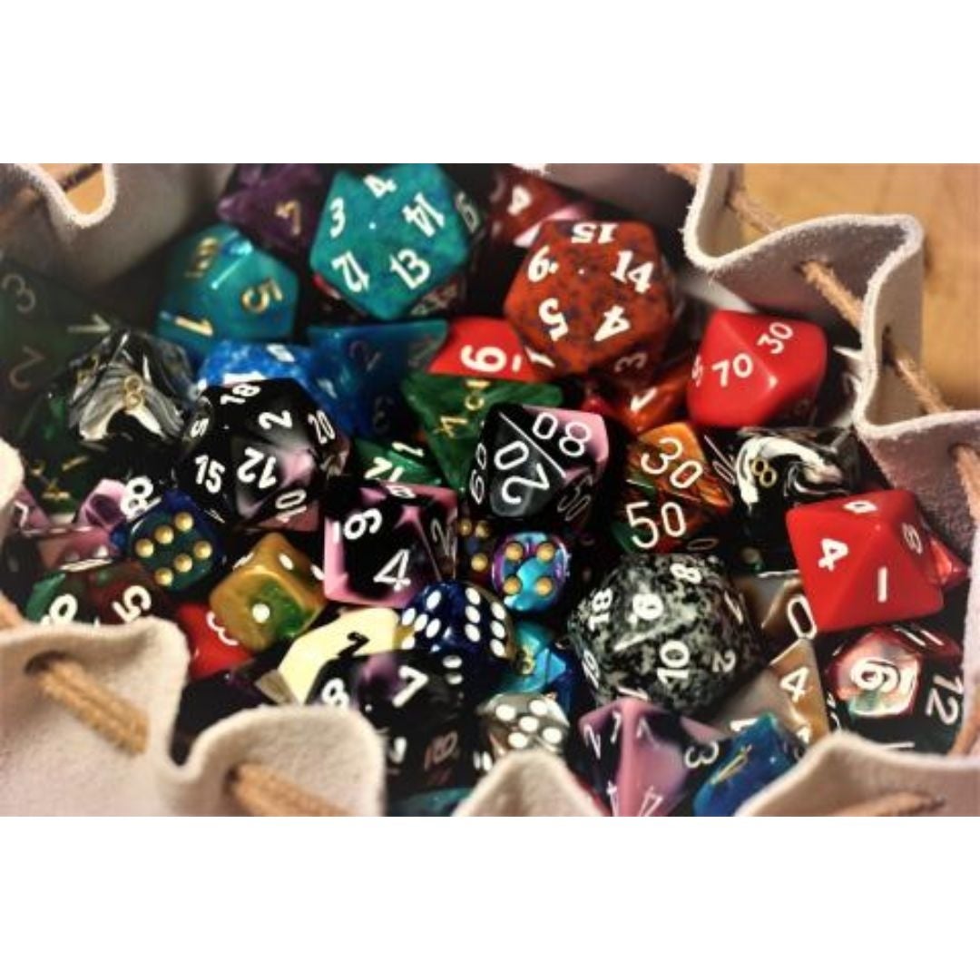 A bag filled with dice with various amounts of sides from 6-20 in all different colors and patterns.