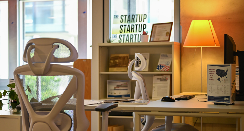 Office chairs around a white desk in a business office setting