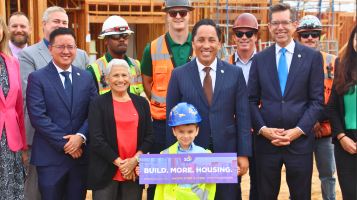mayor of san diego todd gloria stands with city leaders and construction workers 