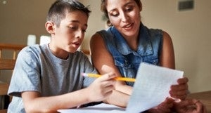 An adult and child working on homework together