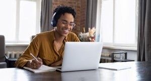 A woman working on laptop at home