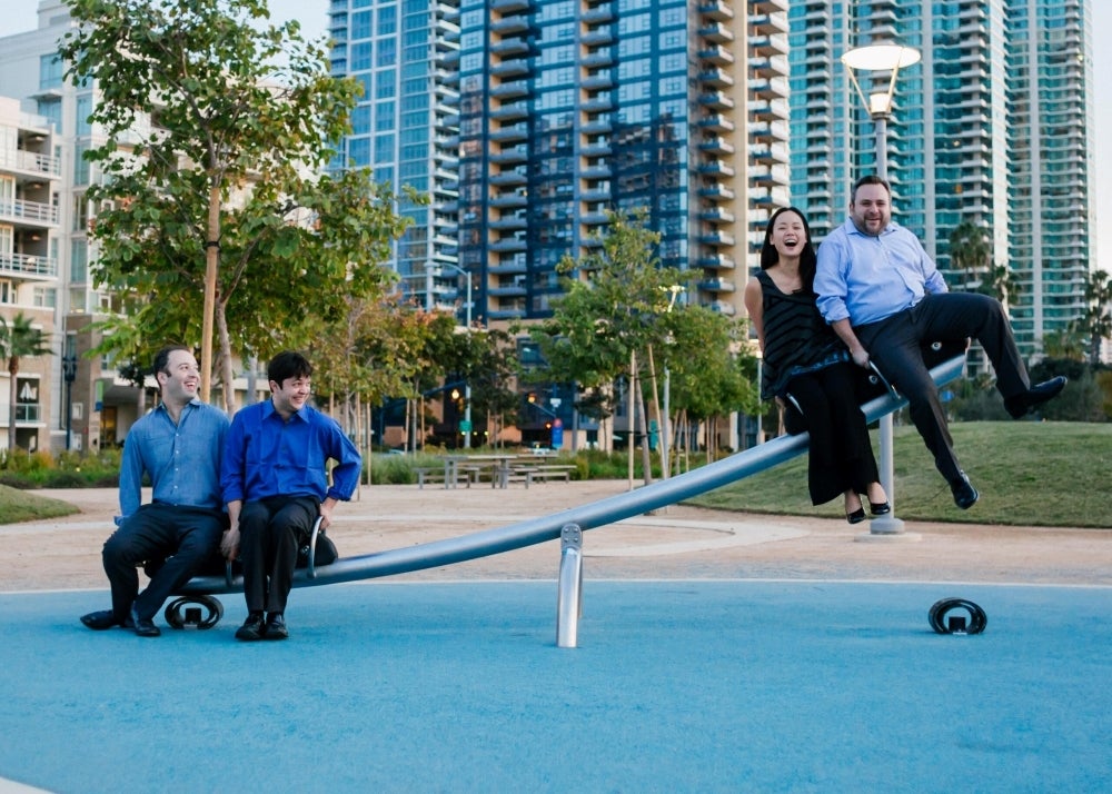 The Haussmann quartet, two members sitting on one end of a seesaw and the other two members on the other end