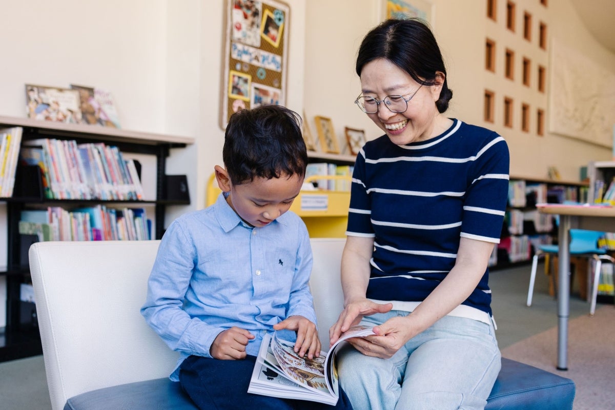 Parent and child reading in library