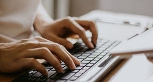 a person typing on a computer keyboard