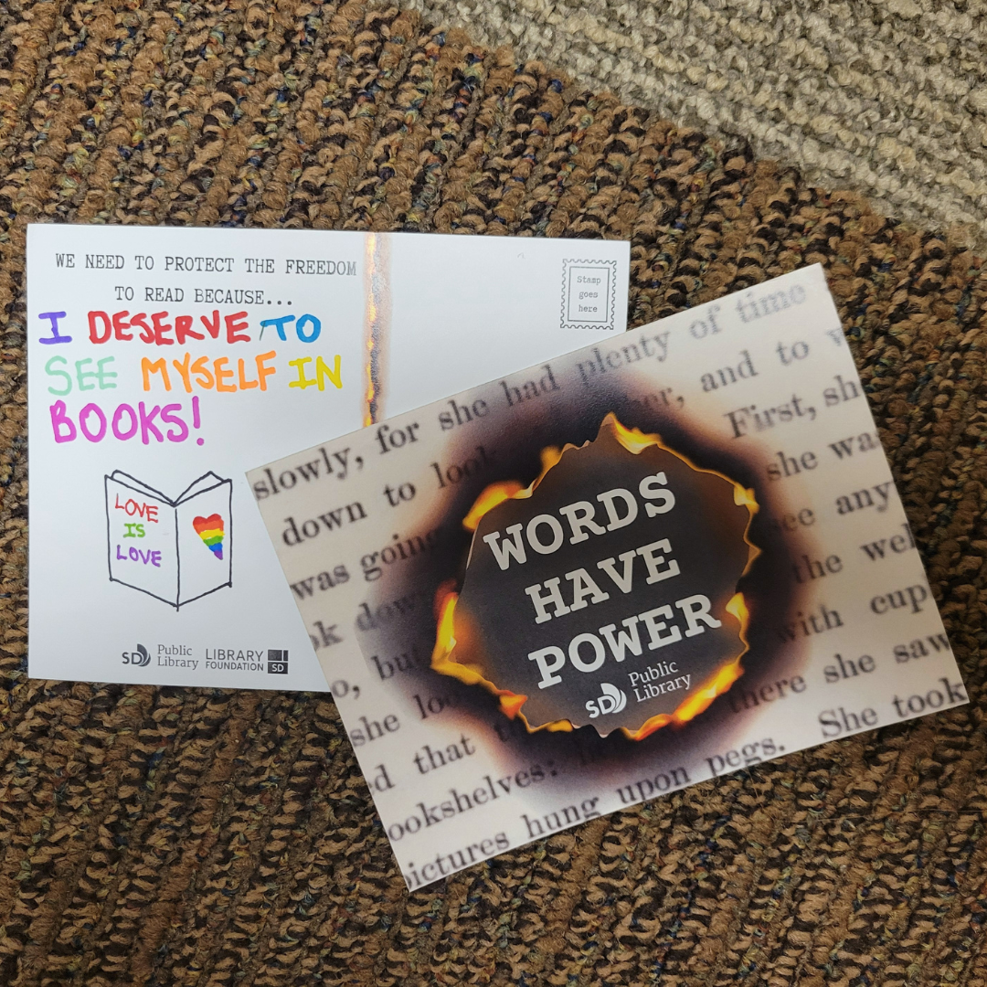 Front and back of two postcards. Front shows written words on the background with a burned hole revealing "Words have power" message.