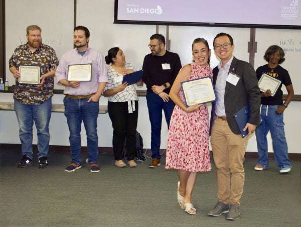 Women poses certificate