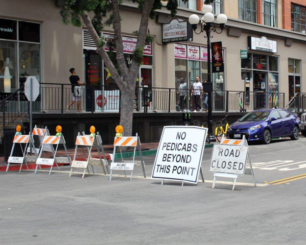 Traffic barricades indicating a closed street in downtown San Diego